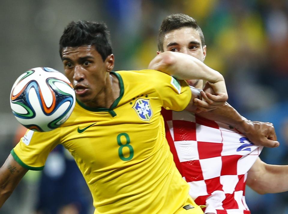 Brazil's Paulinho (L) and Croatia's Sime Vrsaljko fight for the ball during the 2014 World Cup opening match at the Corinthians arena in Sao Paulo June 12, 2014. (REUTERS/Murad Sezer)