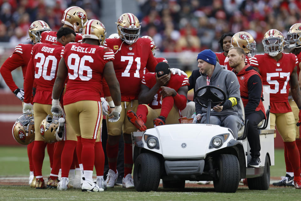 San Francisco 49ers wide receiver Deebo Samuel, middle, reacts as he is carted off the field during the first half of an NFL football game against the Tampa Bay Buccaneers in Santa Clara, Calif., Sunday, Dec. 11, 2022. (AP Photo/Jed Jacobsohn)