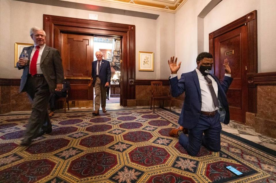 113th District representative Marvin Pendarvis kneels for eight minutes and 46 seconds outside the South Carolina House of Representatives on Wednesday, June 24, 2020. Later the House stood in silence for the amount of time former Minneapolis police officer Derek Chauvin knelt on George Floyd’s neck before his death.