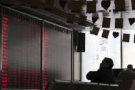 A Chinese man monitors stock prices at a brokerage in Beijing, Friday, Oct. 19, 2018. Asian stock markets sank Friday after Wall Street declined on losses for tech and industrial stocks and Chinese economic growth slowed. (AP Photo/Ng Han Guan)