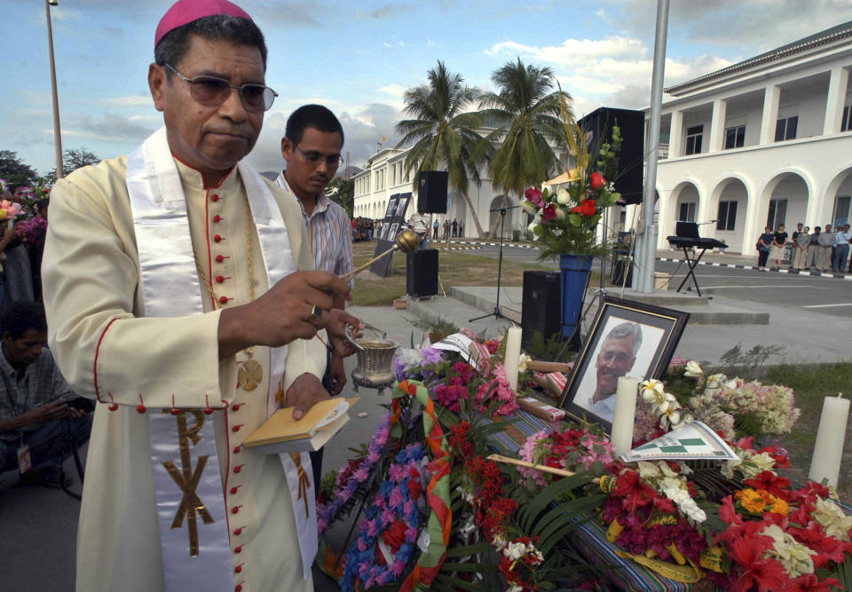 FILE - East Timor's Roman Catholic Bishop and Nobel Prize laureate Carlos Ximenes Belo prays in a ceremony to pay last respects to the former head of the UN Transition Authority in East Timor, Sergio Vieira De Mello in Dili, on Aug. 23, 2003. Belo has been accused in a Dutch magazine article of sexually abusing boys in East Timor in the 1990s, rocking the Catholic Church in the impoverished nation and forcing officials at the Vatican and his religious order to scramble to provide answers. (AP Photo/Firdia Lisnawati, File)