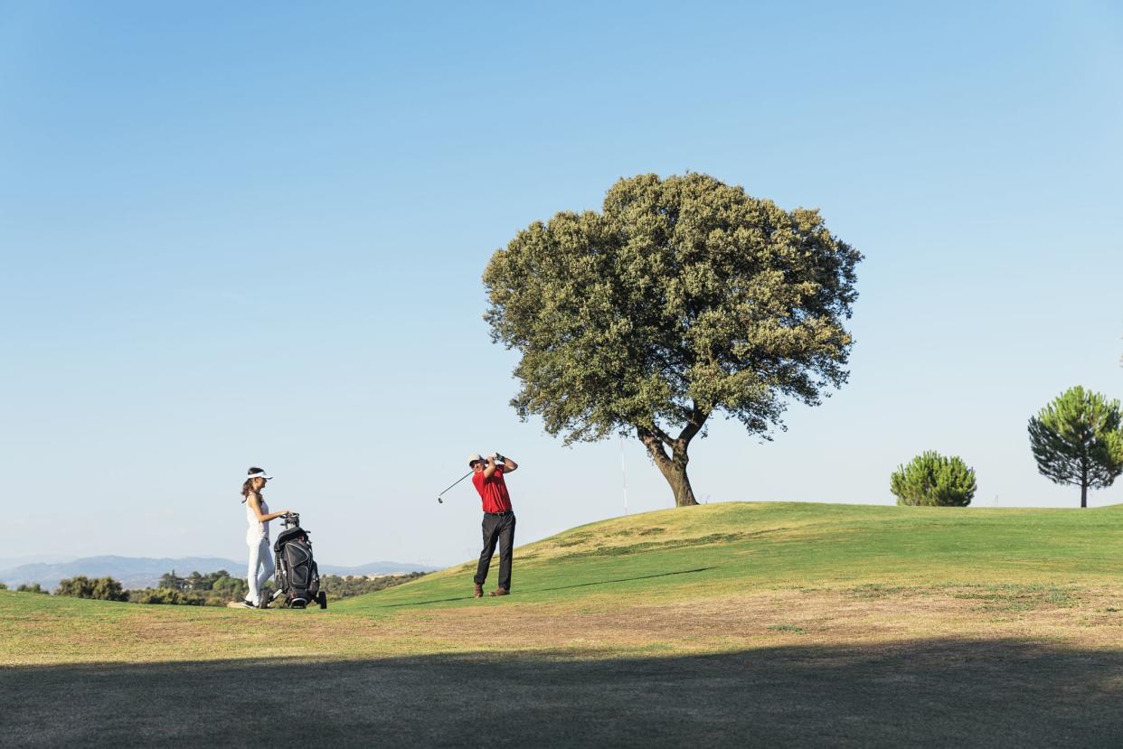 Golfer and Caddie playing golf. Golf Concept.