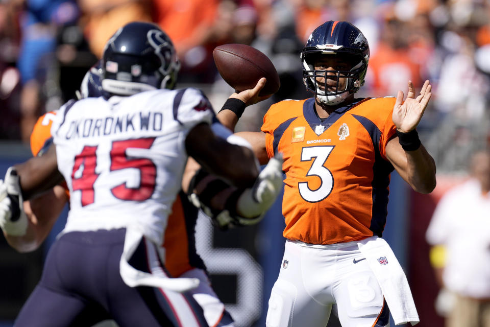 Denver Broncos quarterback Russell Wilson (3) throws as Houston Texans linebacker Ogbonnia Okoronkwo (45) pursues during the first half of an NFL football game, Sunday, Sept. 18, 2022, in Denver. (AP Photo/David Zalubowski)