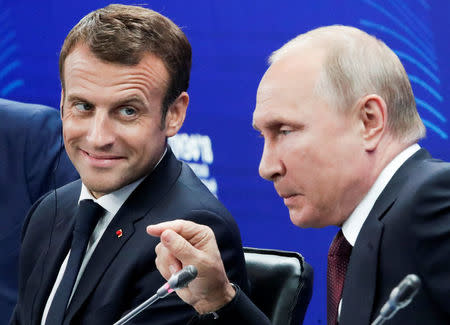 Russian President Vladimir Putin and his French counterpart Emmanuel Macron attend a session of the St. Petersburg International Economic Forum (SPIEF), Russia May 25, 2018. Dmitri Lovetsky/Pool via REUTERS