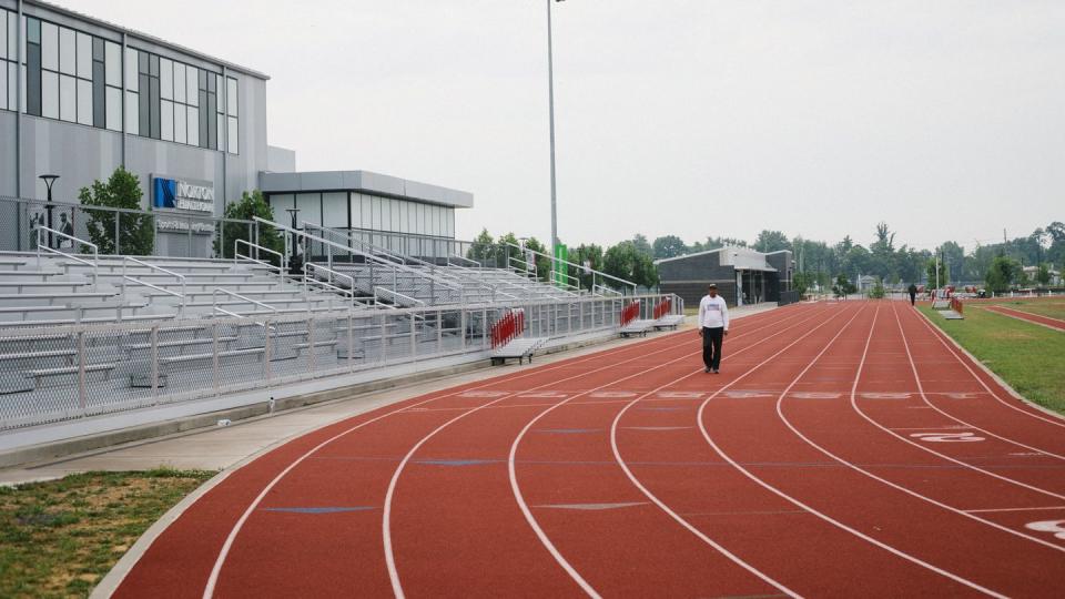 a person standing on an outside track