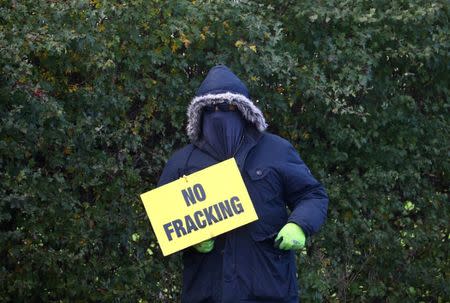 FILE PHOTO: A protester stands outside Cuadrilla's Preston Road fracking site near Blackpool, Britain, October 22, 2018. REUTERS/Hannah McKay/File Photo