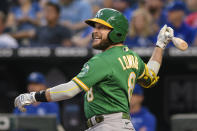 Oakland Athletics' Jed Lowrie hits a sacrifice fly to score teammate Starling Marte during the first inning of a baseball game against the Kansas City Royals, Tuesday, Sept. 14, 2021 in Kansas City, Mo. (AP Photo/Reed Hoffmann)