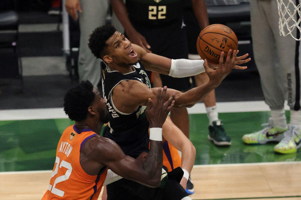 Giannis Antetokounmpo #34 of the Milwaukee Bucks goes up for a shot  against Deandre Ayton #22 of the Phoenix Suns during the second half in Game Six of the NBA Finals at Fiserv Forum on July 20, 2021 in Milwaukee, Wisconsin. / Credit: / Getty Images