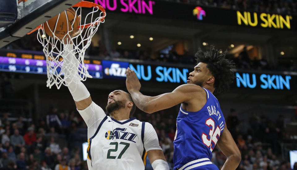 Utah Jazz center Rudy Gobert (27) dunks next to Sacramento Kings forward Marvin Bagley III (35) during the second half of an NBA basketball game Saturday, Jan. 18, 2020, in Salt Lake City. (AP Photo/Rick Bowmer)