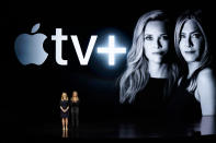 Actors Reese Witherspoon, left, and Jennifer Aniston speak at the Steve Jobs Theater during an event to announce new Apple products Monday, March 25, 2019, in Cupertino, Calif. (AP Photo/Tony Avelar)