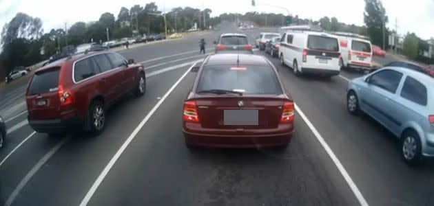 Child forced to dodge heavy traffic on bush highway. Photo: 3AW/YouTube