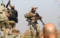 Rapid Response forces members cross farm land during a battle with Islamic State's militants south west of Mosul, Iraq February 24, 2017. .REUTERS/Zohra Bensemra