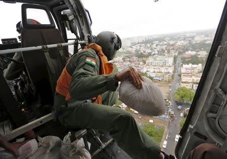 An Indian coast guard personnel prepares to drop relief materials in a flood-affected area in Chennai, India, December 6, 2015. REUTERS/Anindito Mukherjee