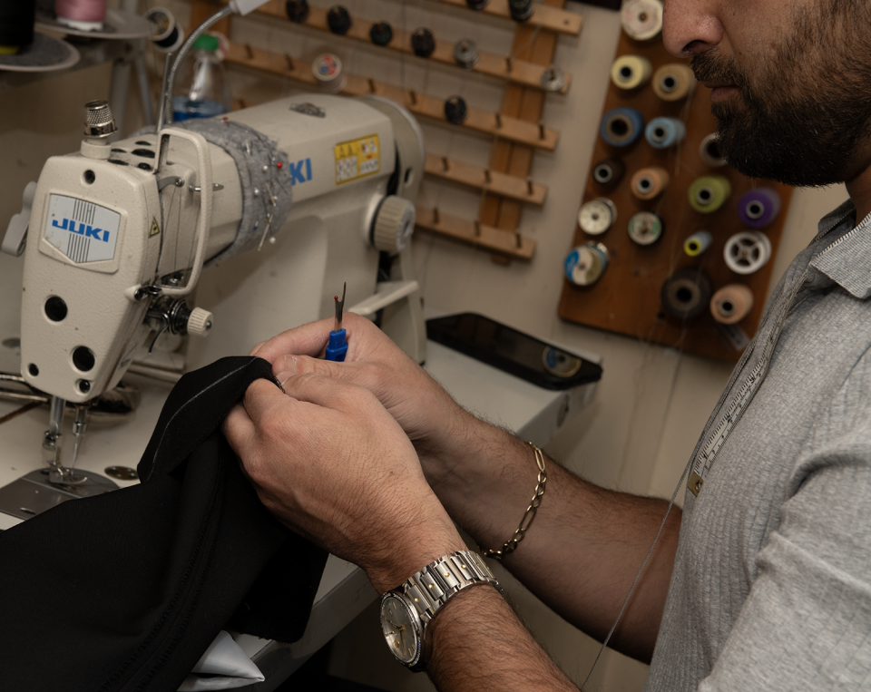 George Jabbour, the owner of Jabbour's Clothing & Tailoring in Stow, works on a pair of pants.