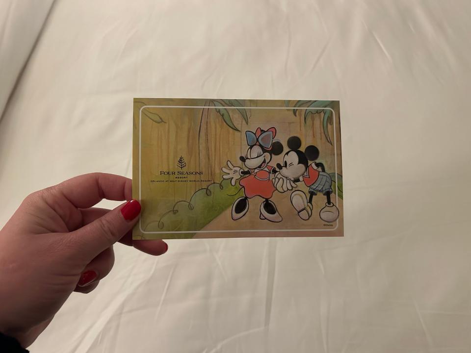 Disney World design on card in hand