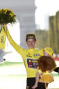 Tour de France winner Denmark's Jonas Vingegaard, wearing the overall leader's yellow jersey, celebrates on the podium after the twenty-first stage of the Tour de France cycling race over 116 kilometers (72 miles) with start in Paris la Defense Arena and finish on the Champs Elysees in Paris, France, Sunday, July 24, 2022. (Etienne Garnier/Pool Photo via AP)