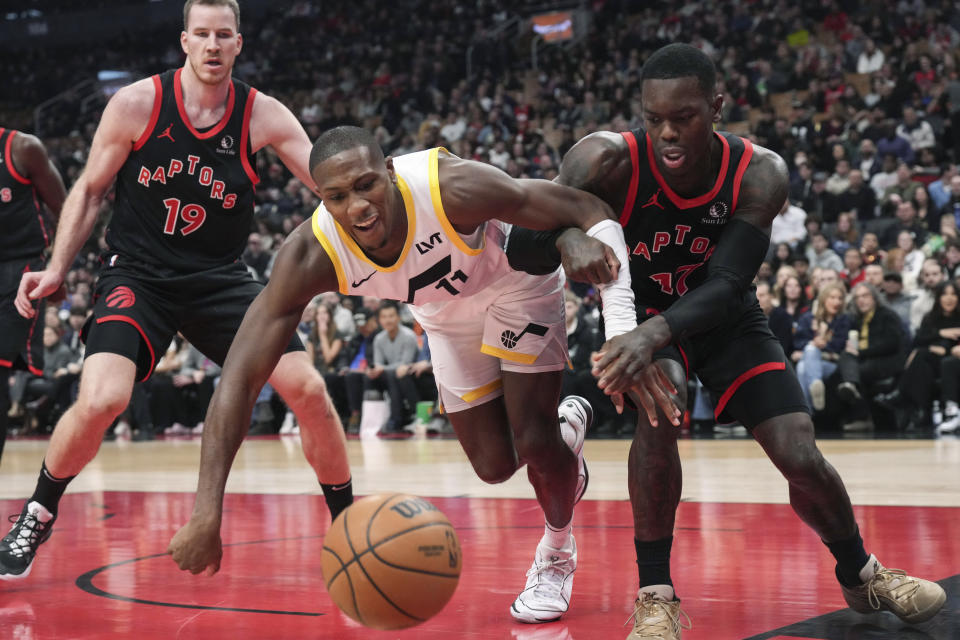 Toronto Raptors guard Dennis Schroder, right, and Utah Jazz guard Kris Dunn (11) watch the ball get away during the first half of an NBA basketball game Saturday, Dec. 23, 2023, in Toronto. (Chris Young/The Canadian Press via AP)