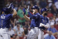 Tampa Bay Rays' Austin Meadows celebrates with Wander Franco after being driven home on a single by Francisco Mejia during the ninth inning of the team's baseball game against the Boston Red Sox at Fenway Park, Tuesday, Aug. 10, 2021, in Boston. At right is Randy Arozarena. (AP Photo/Charles Krupa)