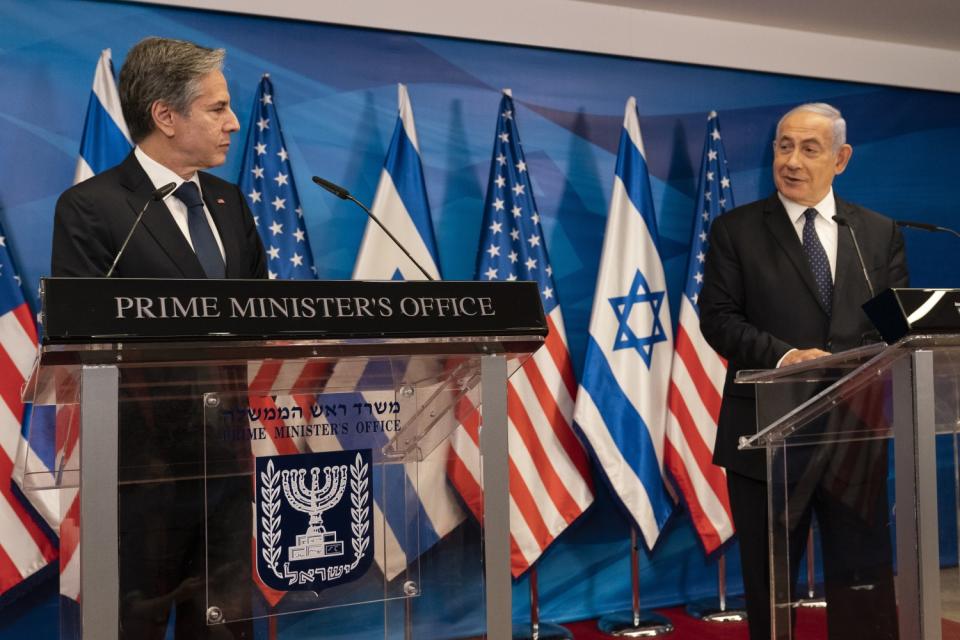 Secretary of State Antony Blinken listens as Israeli Prime Minister Benjamin Netanyahu speaks at a news conference.