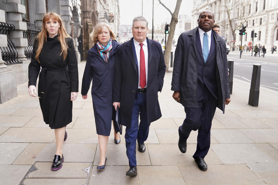 Leading members of the Labour Party head toward the Houses of Parliament for a meeting.