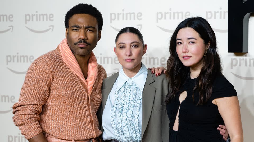 Writer Francesca Sloane (center) attends the UK premiere of "Mr & Mrs Smith" — along with its stars Donald Glover and Maya Erskine — on January 17, 2024 wearing a pair of pearl-embellished Crocs from fashion designer Simone Rocha, as part of a collaboration with the brand. - Samir Hussein/WireImage/Getty Images