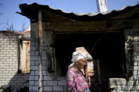 Hanna Sylivon, 76, stands outside her house destroyed by attacks in Chernihiv, Ukraine, Sunday, June 19, 2022. (AP Photo/Natacha Pisarenko)