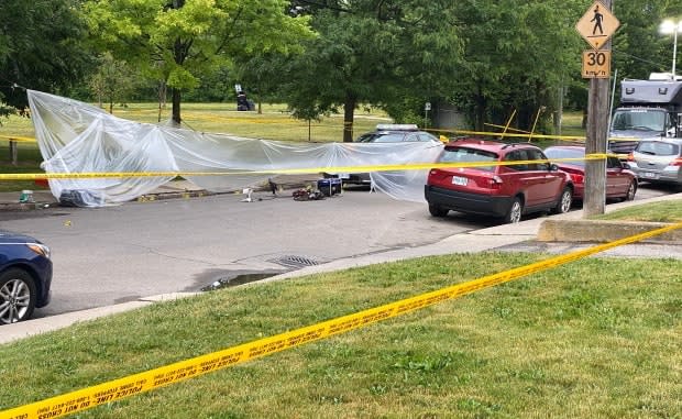 Police used plastic tarps to protect evidence from heavy rain overnight. (Paul Smith/CBC - image credit)