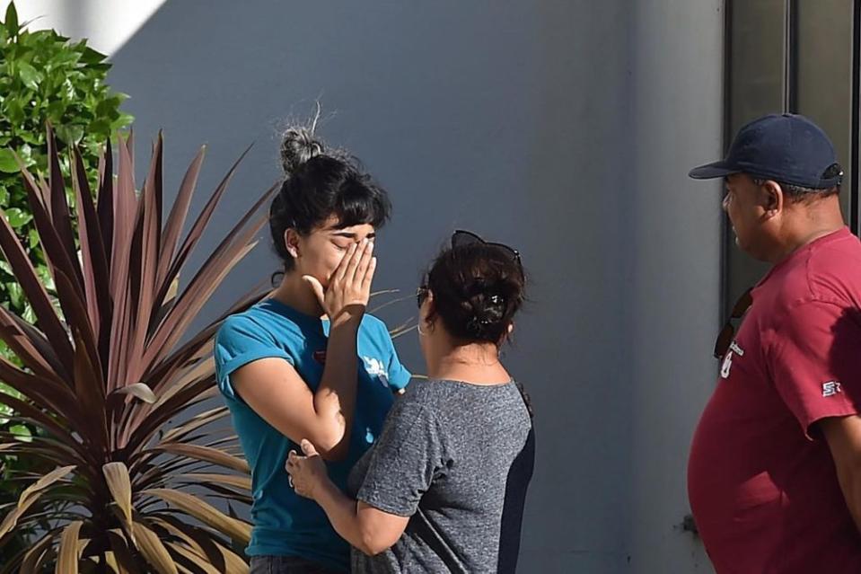 A Trader Joe's employee is comforted after what police described as a hostage situation at the grocery chain's location in L.A.'s Silver Lake neighborhood on Saturday.