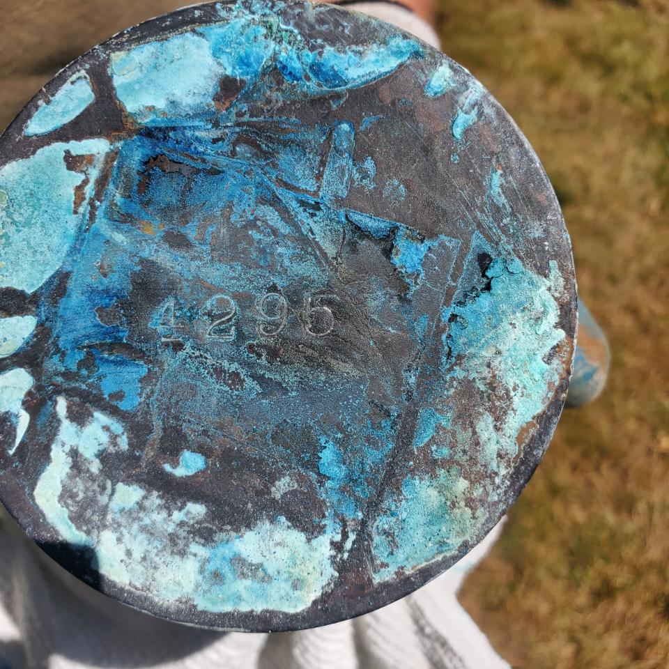 Cremated ashes in a copper canister are disinterred July 6 at Belcrest Memorial Park in Salem. A local family discovered the cremains they'd buried were not of their grandmother, Carrie Ethel Hardy.