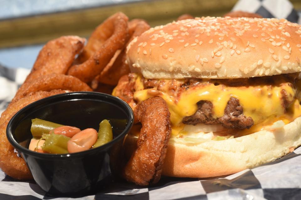 Carolina Burger served with onion rings at Winnie's Tavern in Wilmington, N.C.  [KEN BLEVINS/STARNEWS]