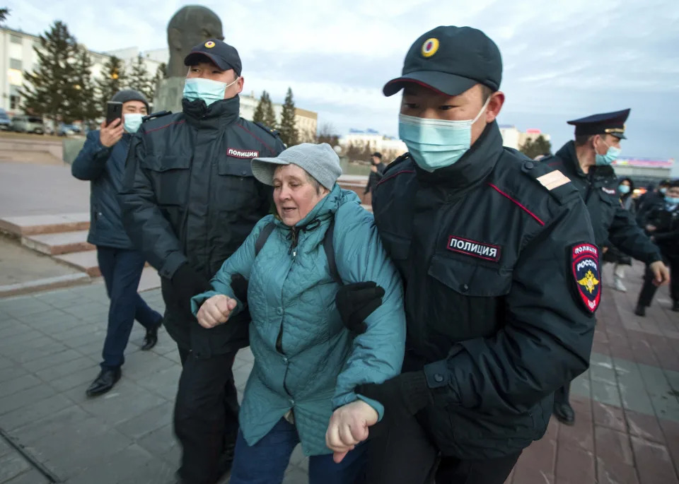 FILE - Police officers detain a woman during a protest in support of jailed opposition leader Alexei Navalny in Ulan-Ude, the regional capital of Buryatia, a region near the Russia-Mongolia border, Russia, Wednesday, April 21, 2021. In the last two years, ordinary Russians have been increasingly swept up in an unprecedented government crackdown, together with opposition politicians, independent journalists and human rights activists. (AP Photo, File)