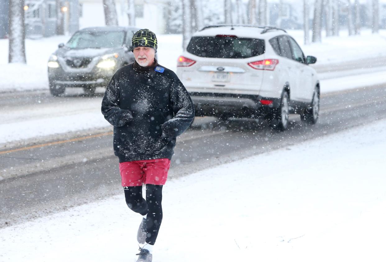 Ray Salemink runs along Jefferson Boulevard on Wednesday, Jan. 25, 2023, in South Bend. But there won't be as much of that snowfall in the coming week.