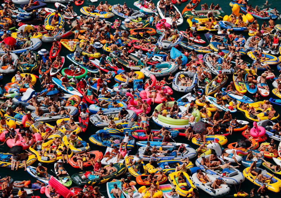 <p>People on inflatable boats enjoy the weather on the Lake Lucerne in Sisikon, Switzerland, Aug. 5, 2018. (Photo: Denis Balibouse/Reuters) </p>