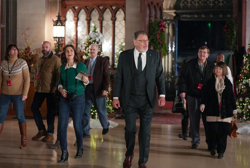 In Hallmark's "A Biltmore Christmas," a group tours the Biltmore House in Asheville. Pictured: A.K. Bennington and Jonathan Frakes.