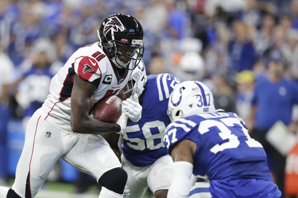 Atlanta Falcons wide receiver Julio Jones (11) is tackled by Indianapolis Colts safety Khari Willis (37) during the first half of an NFL football game, Sunday, Sept. 22, 2019, in Indianapolis. (AP Photo/Michael Conroy)