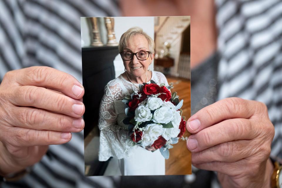 Dorothy "Dottie" Fideli  holds a picture of herself in a wedding dress while in Goshen, Ohio, on Wednesday, June 28, 2023. Fideli is known for marrying herself at her retirement home. 