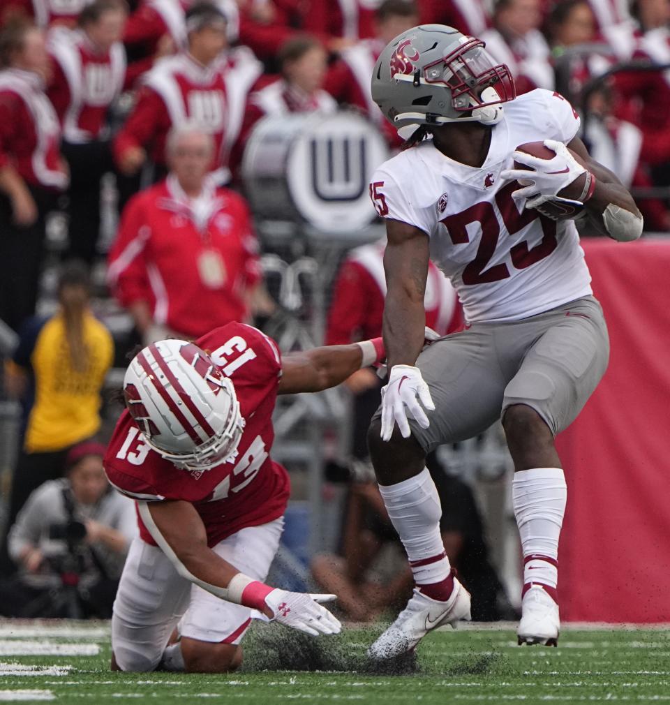 Wisconsin safety Kamo'i Latu (13) misses a tackle on Washington State running back Nakia Watson that in a 31-yard touchdown reception during the third quarter of their game Saturday, September 10, 2022 at Camp Randall Stadium in Madison, Wis. Washington State beat Wisconsin 17-14.