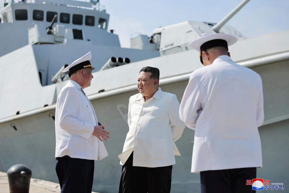 In this undated photo provided on Monday, 21 August 2023, by the North Korean government, North Korean leader Kim Jong-un, centre, visits a navy flotilla in North Korea (AP)