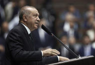 Turkey's President Recep Tayyip Erdogan addresses his ruling party MPs, in Ankara, Turkey, Tuesday, June 25, 2019, two days after Ekrem Imamoglu, the candidate of the secular opposition Republican People's Party, won the election for mayor of Istanbul. Erdogan addressed his AK Party's weekly meeting, the first time he speaks since the Istanbul mayoral election Sunday, which was a big setback for him and his party. (AP Photo/Burhan Ozbilici)