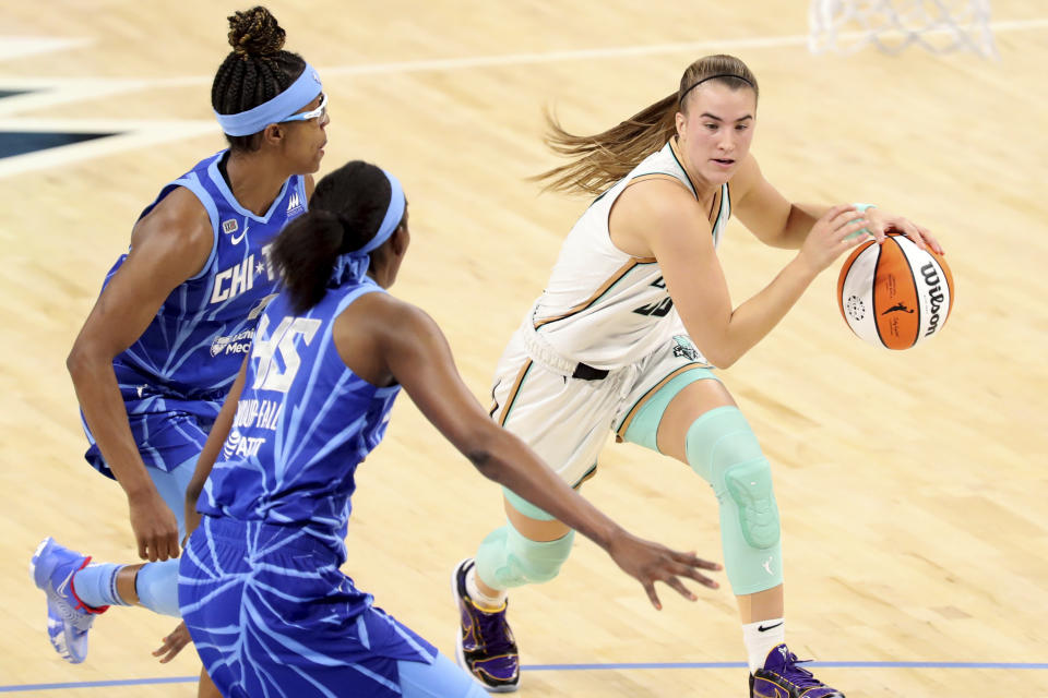 New York Liberty guard Sabrina Ionescu (20) tries to get past Chicago Sky guard Diamond DeShields, left, and center/forward Astou Ndour-Fall (45) during a their game on May 23, 2021. (AP Photo/Eileen T. Meslar)