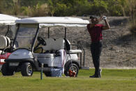 Tiger Woods watches his shot during a training session at the Albany Golf Club, in New Providence, Bahamas, Sunday, Dec. 5, 2021.(AP Photo/Fernando Llano)