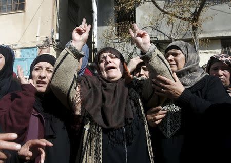 The mother (C) of Palestinian youth Omar Madi, who was shot and killed by Israeli troops on Wednesday, mourns during his funeral in Arroub refugee camp, north of the West Bank city of Hebron, February 11, 2016. REUTERS/Mussa Qawasma