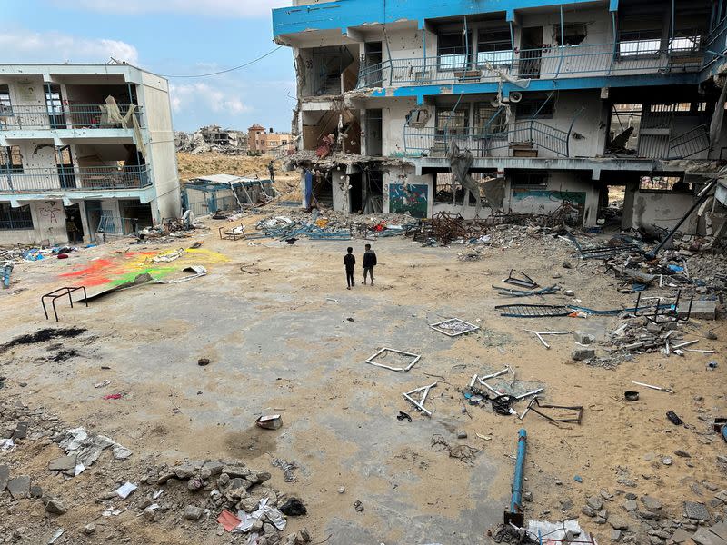 FILE PHOTO: Palestinian children inspect their destroyed school in the southern Gaza Strip