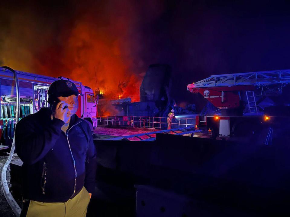 Mikhail Razvozhayev, the Moscow-appointed governor of Sevastopol, said on Sept. 13, 2023, that 24 people were injured in a Ukrainian missile strike on a shipyard. He posted a photo of himself showing the shipyard in flames behind him. / Credit: Telegram/Mikhail Razvozhayev