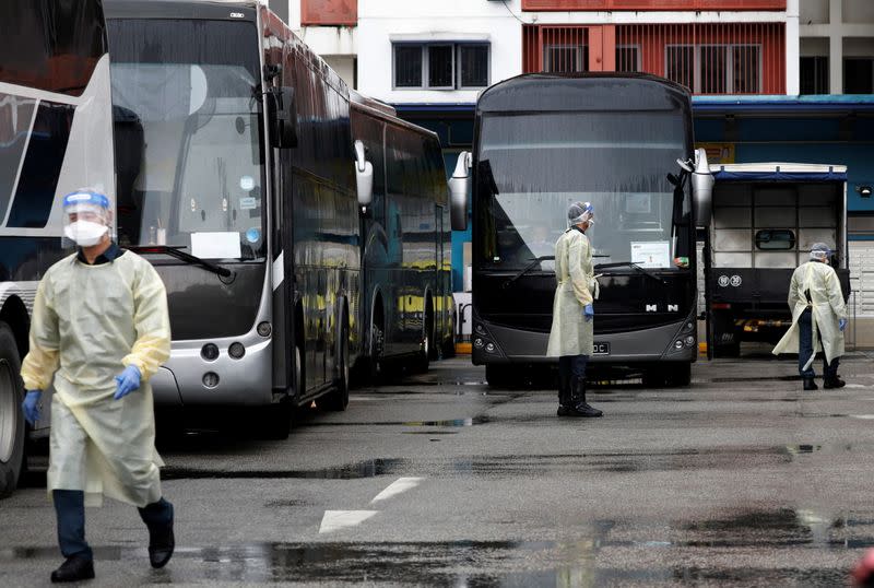 Buses stand by to transport migrant workers to a government quarantine facility after workers were tested positive for the coronavirus disease (COVID-19) at Westlite Woodlands dormitory in Singapore