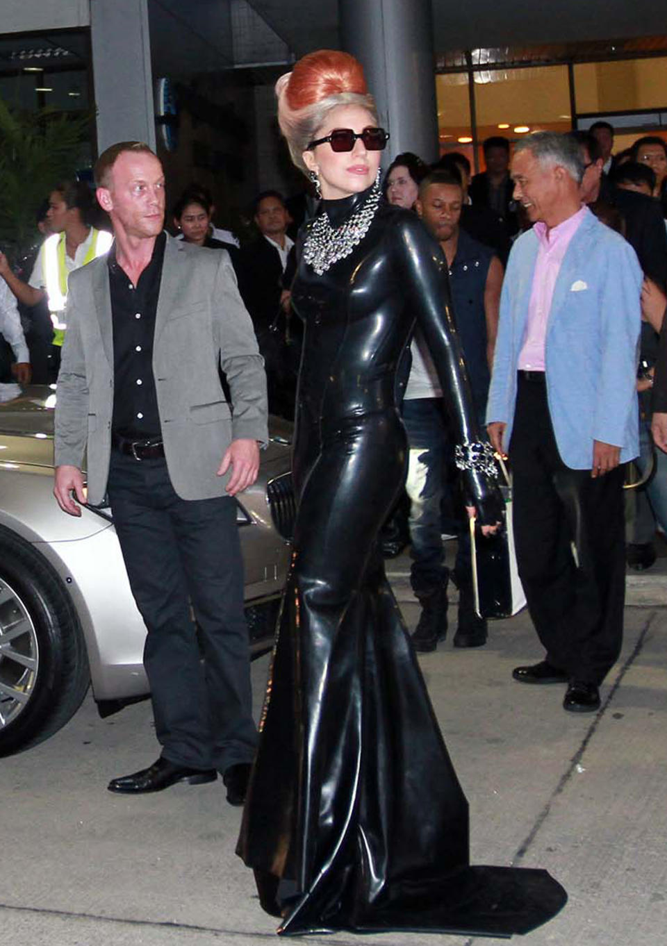 U.S. singer Lady Gaga pauses while making her way to a waiting car upon her arrival at Don Muang airport in Bangkok, Thailand Wednesday, May 23, 2012. Lady Gaga is performing a concert in Bangkok on Friday, May 25, 2012.  (AP Photo)