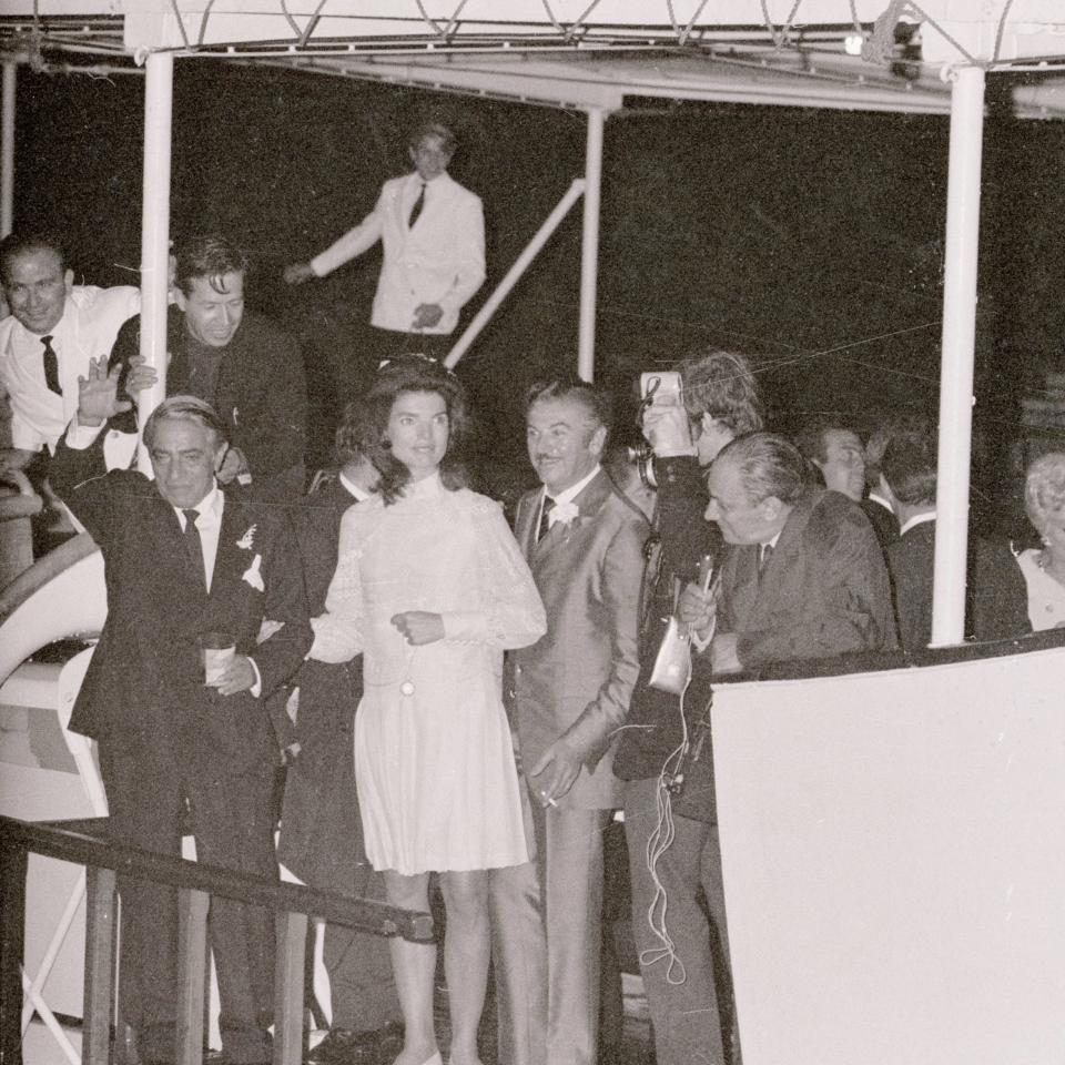 Aristotle Onassis, with his bride, Jacqueline Kennedy, by his side, waves from his yacht Christina after their wedding on Skorpios Island