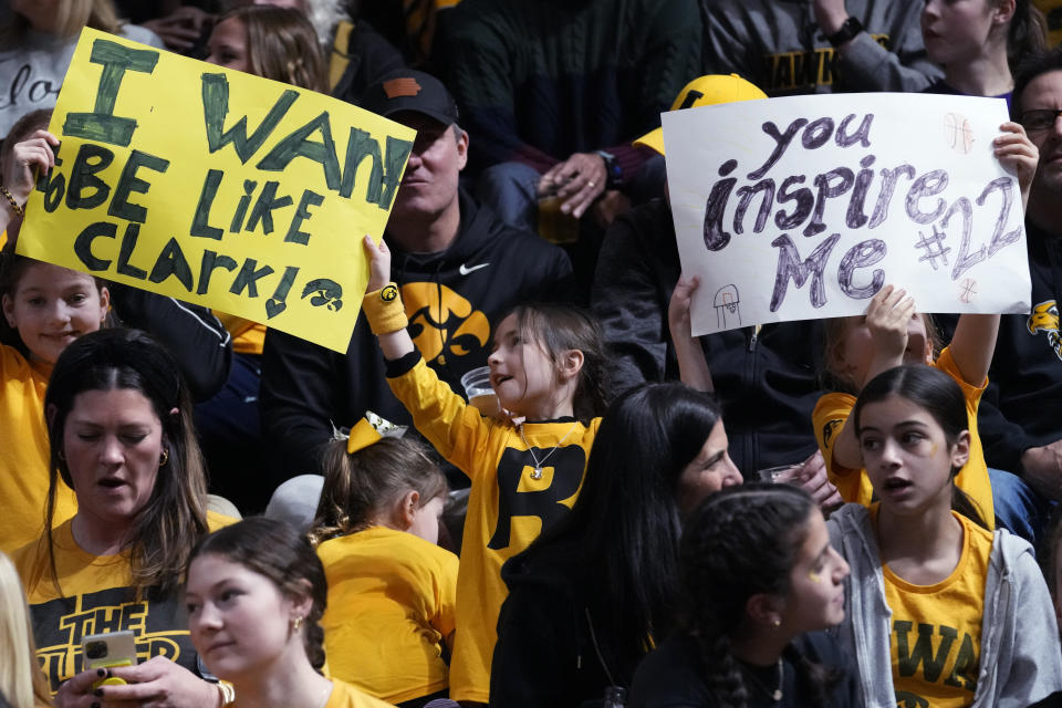Supporters hold signs for Iowa guard Caitlin Clark before an NCAA college basketball game between Iowa and Northwestern in Evanston, Ill., Wednesday, Jan. 31, 2024. (AP Photo/Nam Y. Huh)
