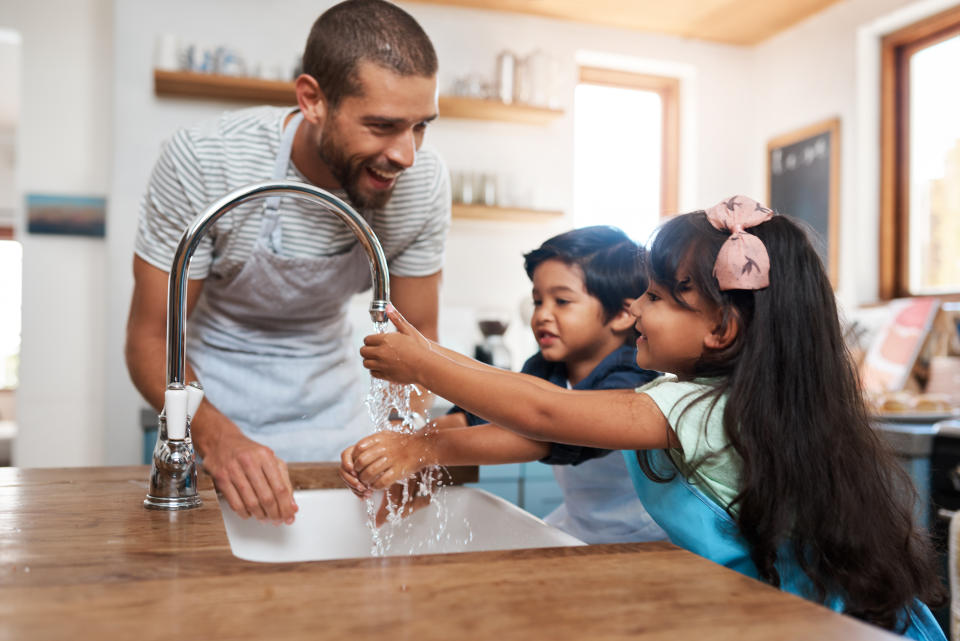 Family washing hands. (Getty Images)