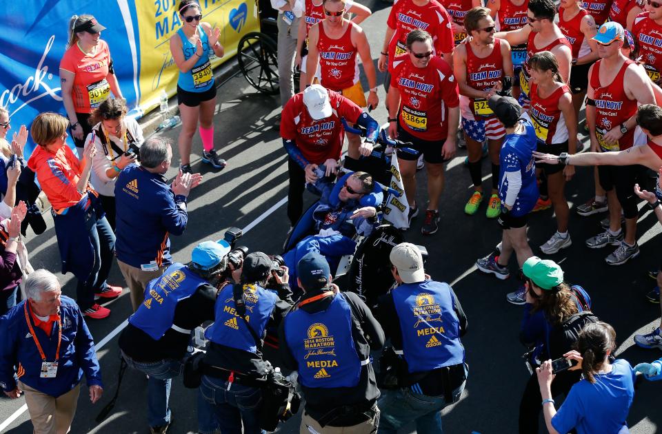 BOSTON, MA - APRIL 21:  Team Hoyt crosses the finish line of the 118th Boston Marathon on April 21, 2014 in Boston, Massachusetts.  (Photo by Jim Rogash/Getty Images)